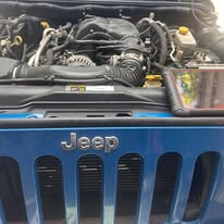 Vehicle engine bay during a mobile service visit